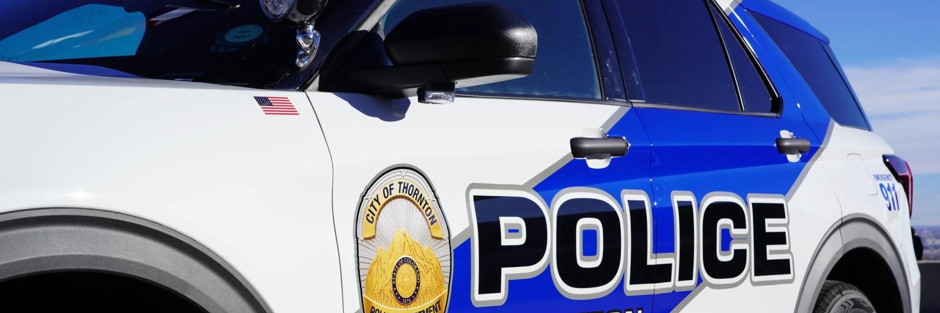 close up of white and blue Thornton police SUC