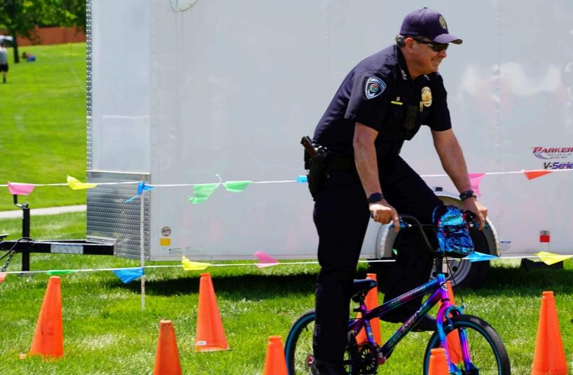police officer riding bicycle through cone course