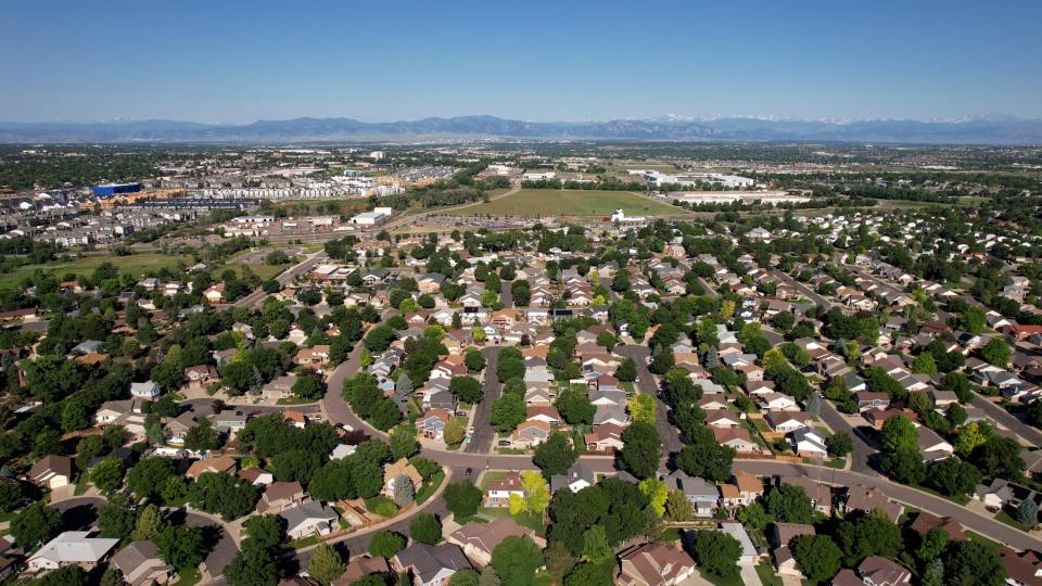 Drone image overlooking the city of Thornton with mountains in the distance.
