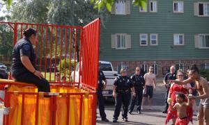 police officer sitting on dunk tank ledge