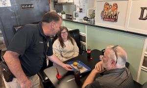 police officer serving donuts to residents